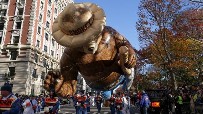 Handlers guide the Smokey Bear balloon along Central Park West during the Macy's Thanksgiving Day parade, Thursday, Nov. 23, 2023, in New York. (AP Photo/Jeenah Moon)